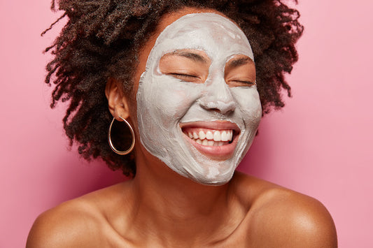woman's head and shoulders wearing a clay detoxifying face mask