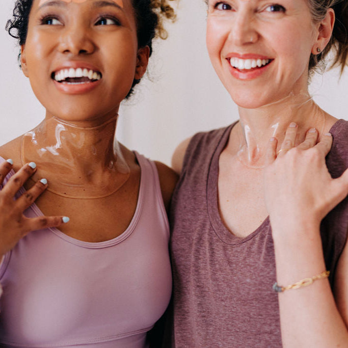 2 woman pictured wearing Frownies apple neck masks while being cheerful