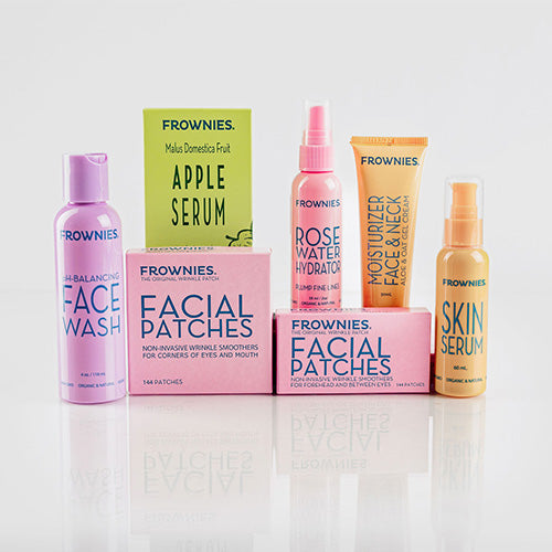 seven products in Frownies Complete Skincare Set including ph balancing face wash, frownies facial patches for corners of the eyes and mouth, frownies facial patches for forehead and between the eyes, rose water hydrator spray, apple serum, moisturizer, and skin serum