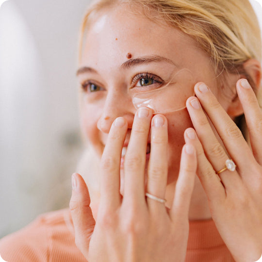 blonde woman applying clear frownies caactus collagen under eye gels