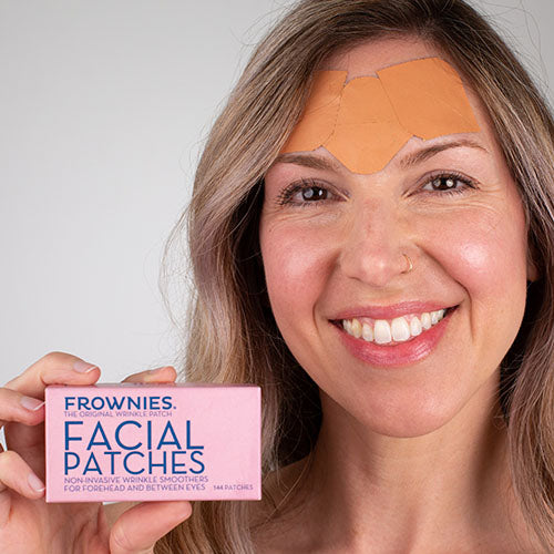 woman holding pink box of frownies facial patches to smooth forehead wrinkles Frownies Starter Kit Facial Patches The Frownies   
