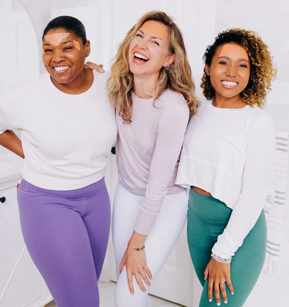 three woman smiling wearing frownies facial patches to smooth forehead wrinkles