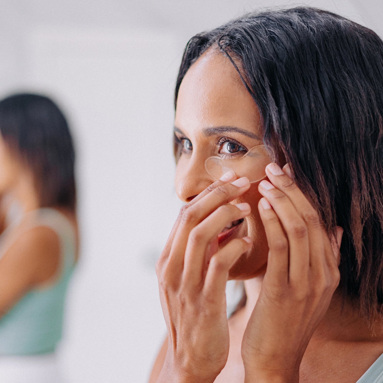 Frownies under eye gels being applied beneath the eye, showing how they look once placed on the skin.