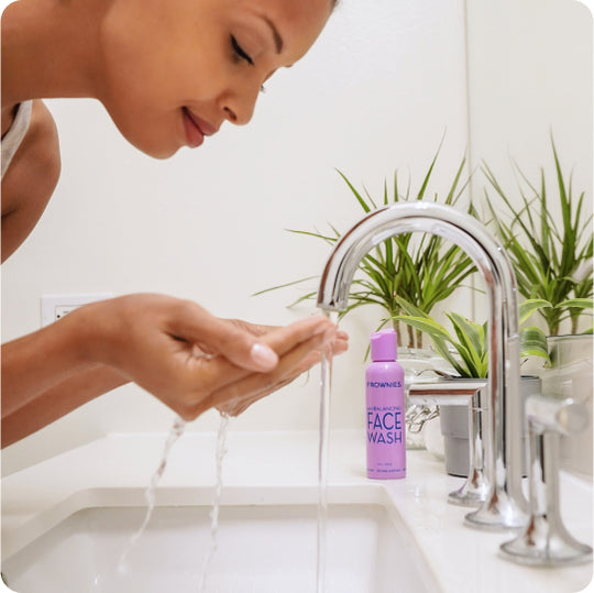woman washing her face with ph balancing face wash