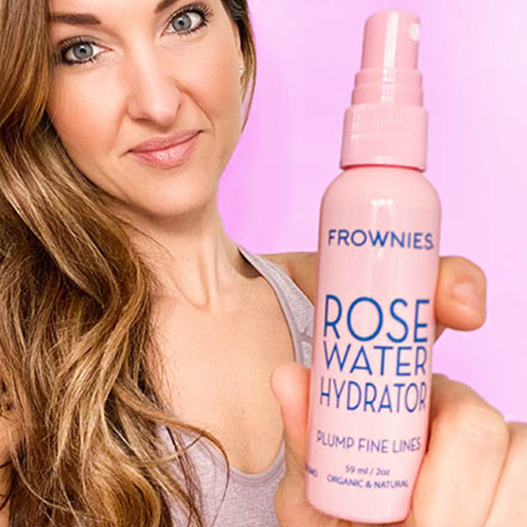 woman holding pink bottle of Rose Water Hydrator Spray (2 oz) Facial Patches Frownies   
