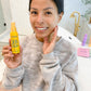 woman touching face holding yellow bottle of Vitamin C & E Skin Serum (2 oz) Skincare Products Frownies   