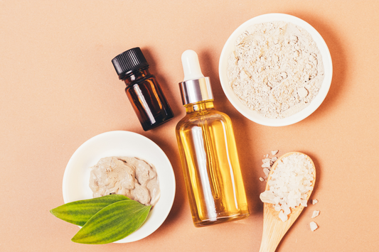 A flat lay of skincare products including a bottle of castor oil 