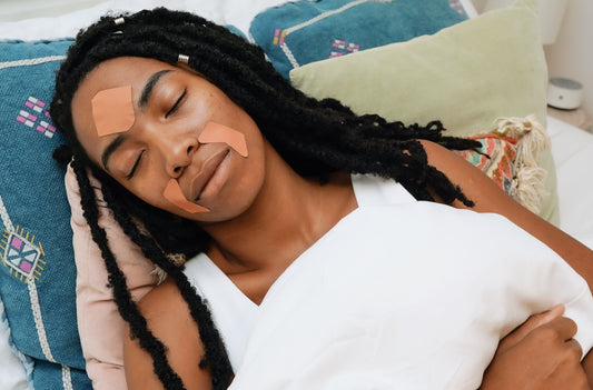 black woman with dreadlocks sleeping with Frownies Facial Patches on forehead wrinkles and around the mouth