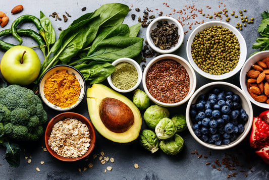 various colorful foods such as apples, blueberries, almonds, and avocados meant to improve skin's appearance