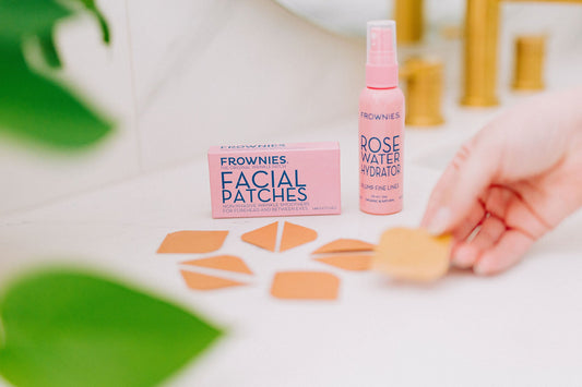 Frownies facial patches and a rose water hydrator on a bathroom countertop