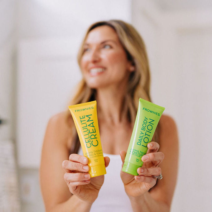 woman in background holding cellulite cream in yellow tube and body lotion in green tube
