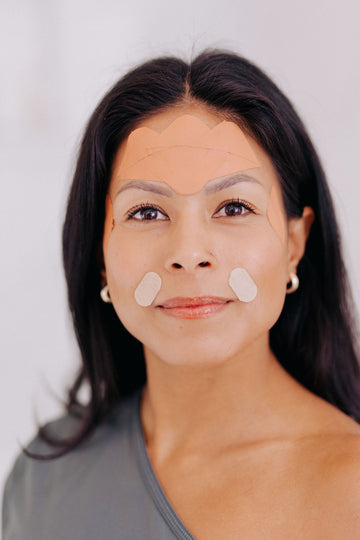 Mixed race woman wearing Frownies wrinkle patches and gentle lifts