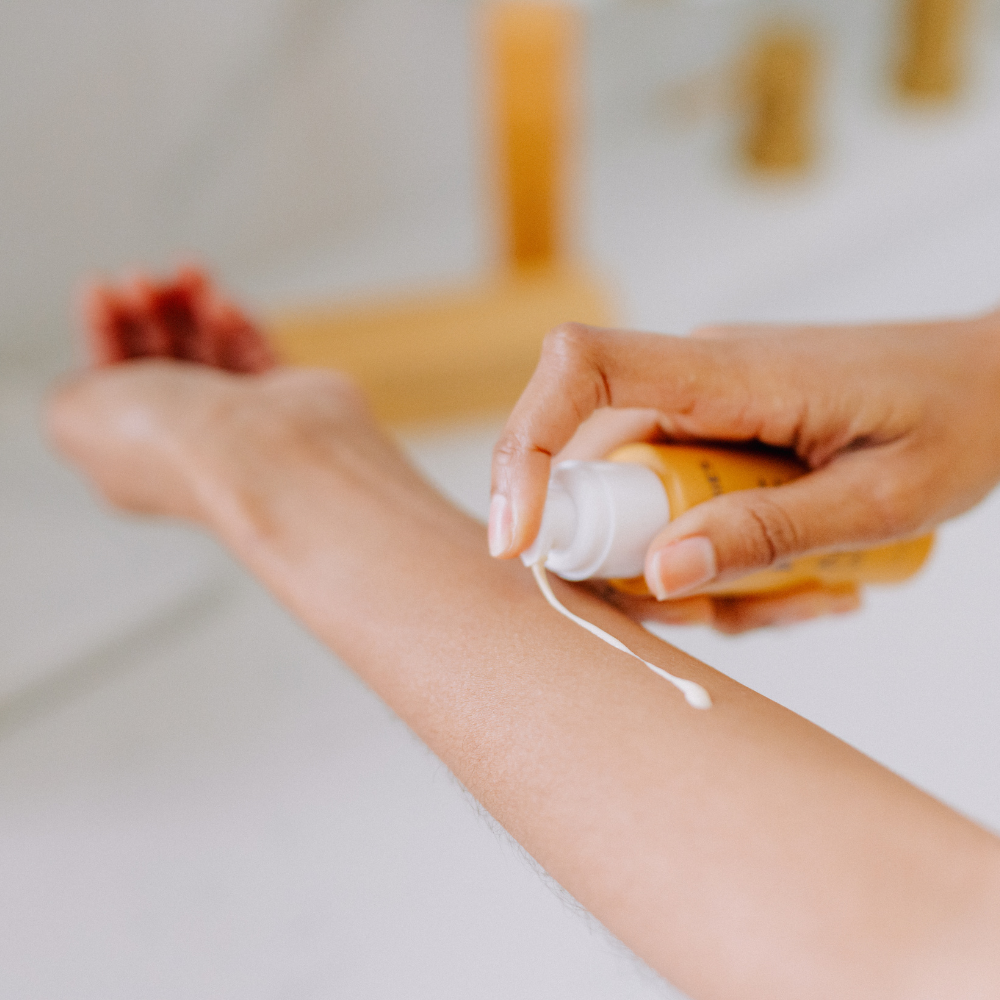 person applying the Frownies facial moisturizer to their arm 
