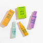 Frownies skincare products including Face & Neck Moisturizer, Apple Serum, Calming Balance Toner, Skin Serum, and Face Wash on a white background.
