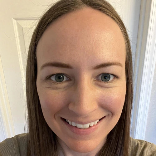 close up of woman's smiling face with smooth forehead