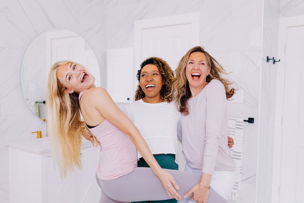 three woman laughing playfully wearing frownies facial patches on forehead to smooth 11 lines and forehead wrinkles