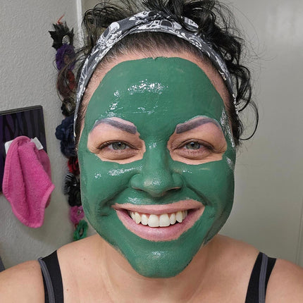 smiling woman wearing green clay face mask detoxify pores