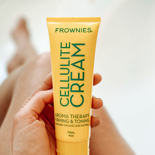 hand holding Natural Firming and Toning Cream Skincare Products Frownies   