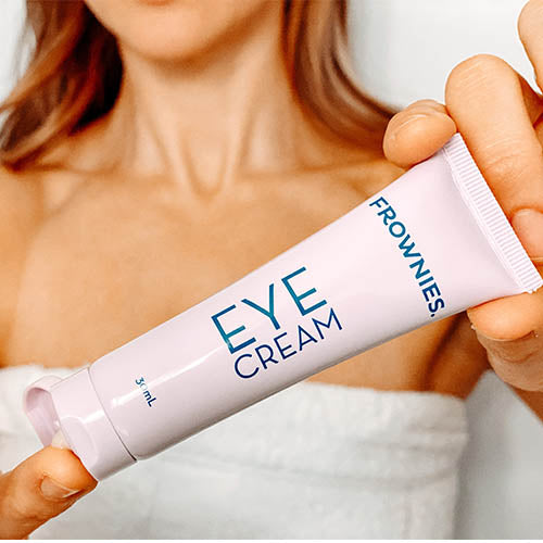 woman squeezing Vitamin E Eye Cream Skincare Products Frownies   