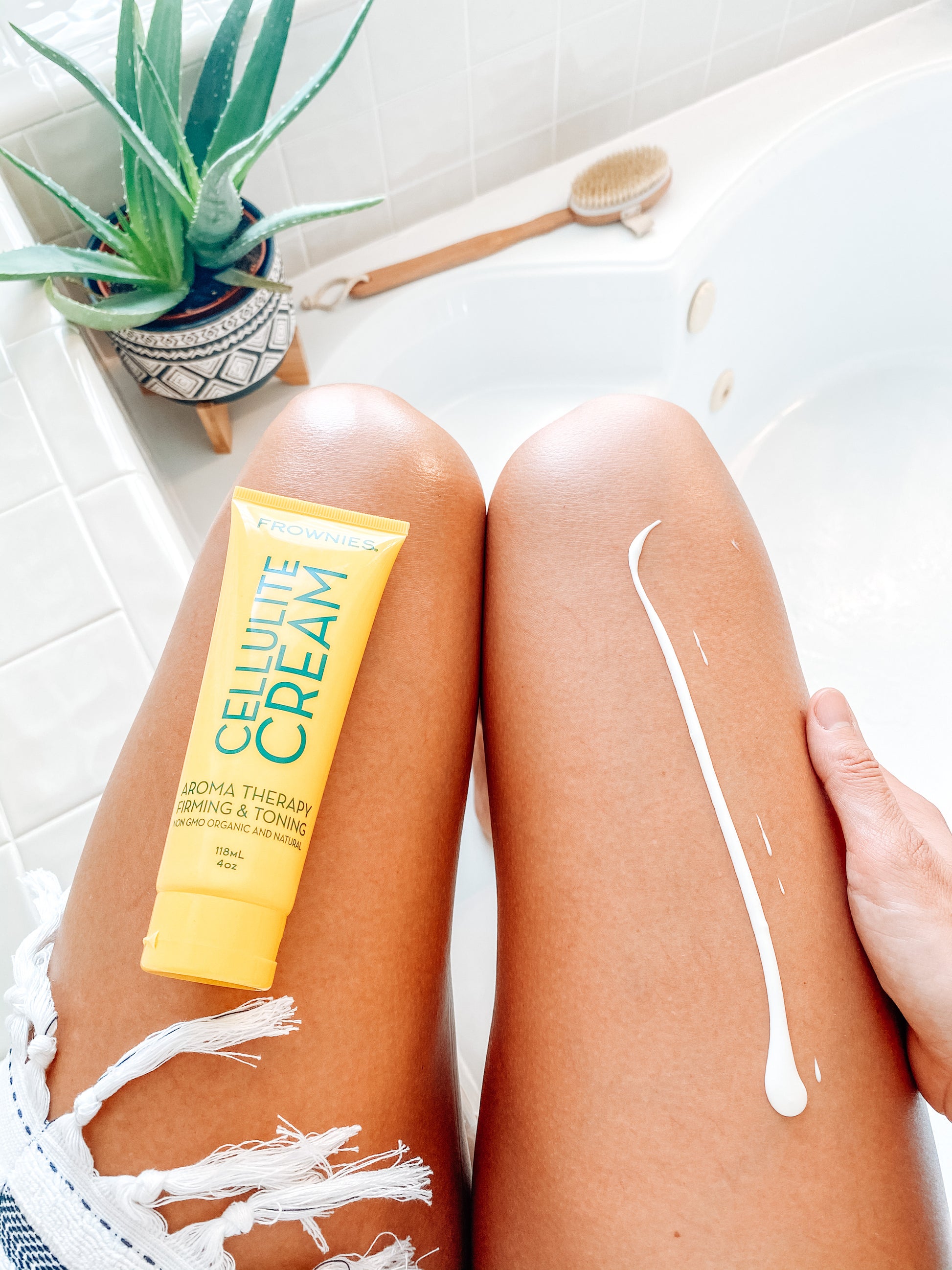 woman's legs with yellow tube of frownies Natural Firming and Toning Cream Skincare Products Frownies   