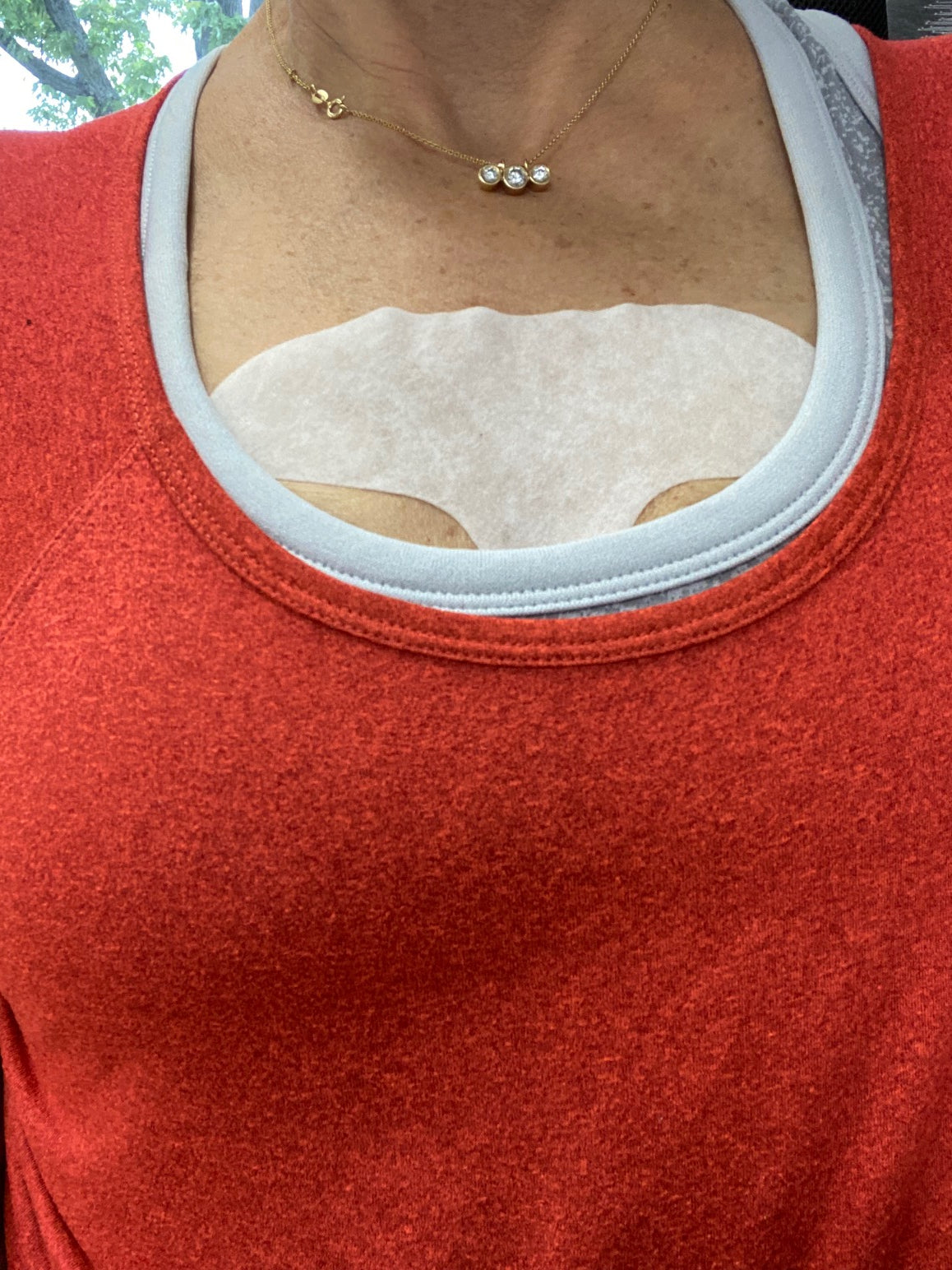 woman's chest in red top wearing Serum Patch for Forehead Wrinkles Facial Patches Frownies   