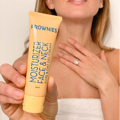 woman touching neck holding Aloe & Oat Gel Moisturizer Face & Neck (2 oz) Skincare Products Frownies   